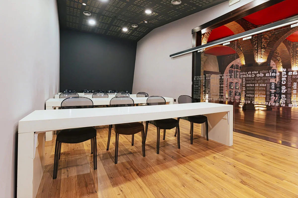 Mesas y sillas en formato teatro en la sala de catas de la Hacienda Señorío de Nevada