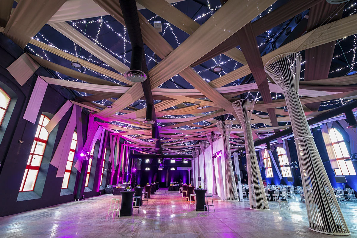 Mesas alta para cóctel y sillas altas colocadas en el interior de La Azucarera para la celebración de un cóctel de empresa en Granada